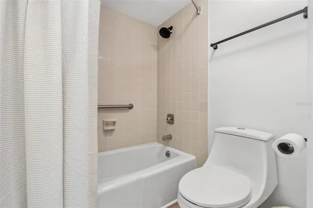 a white toilet and shower