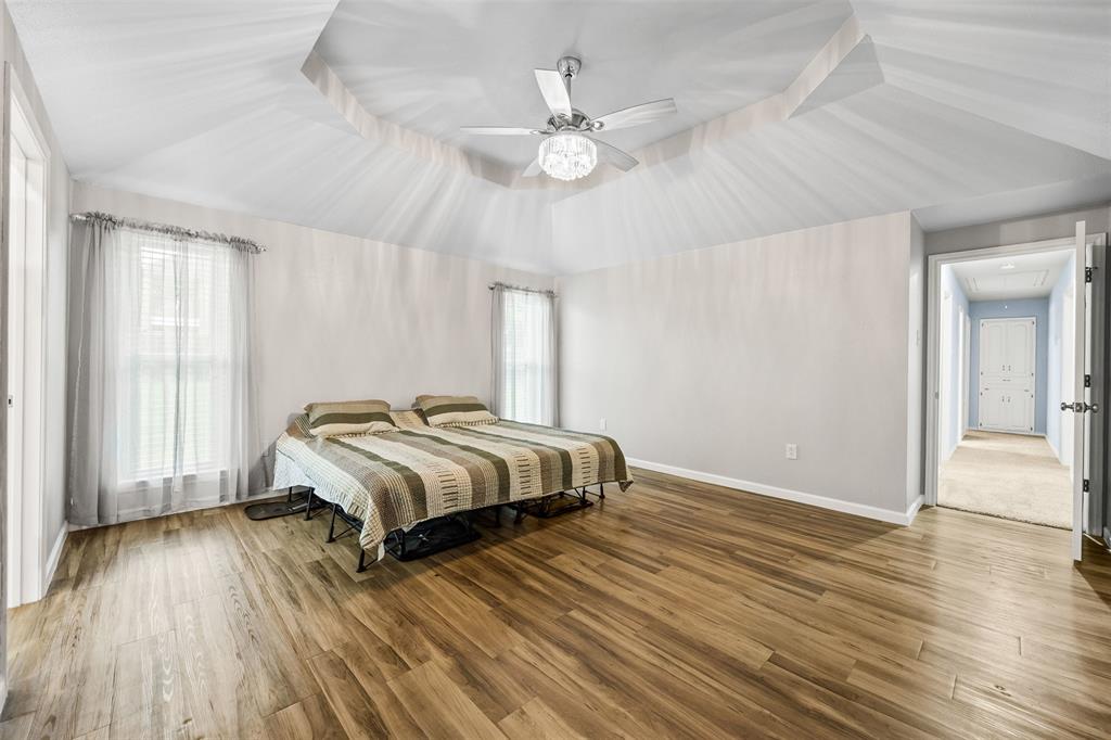 909 Valley View Avenue Red Oak, TX 75154 - Photo 20 of 37 a bedroom with a bed and wooden floor