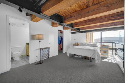 a spacious bedroom with a bed and a table