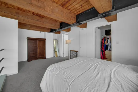 a bedroom with a large bed and a walk in closet