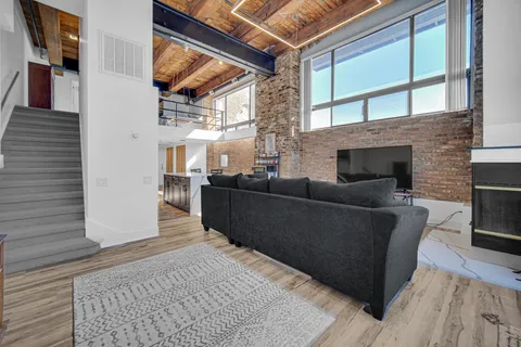 a living room with furniture and a fireplace