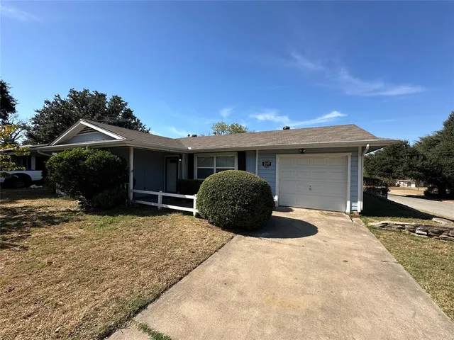 a view of a house with a yard and garage