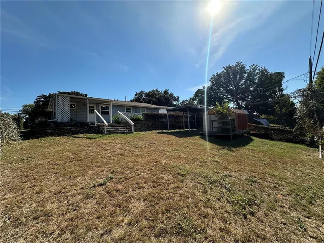 a view of a backyard with pathway