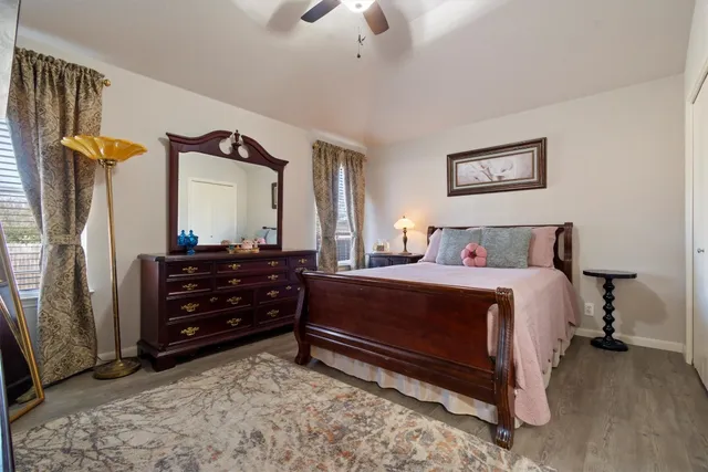 a bedroom with a bed dresser and a window