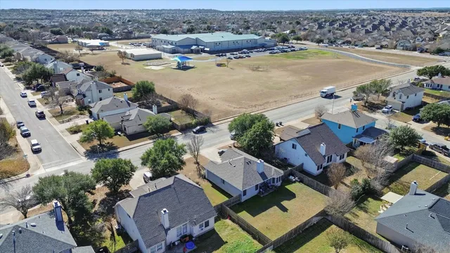 an aerial view of residential houses with outdoor space