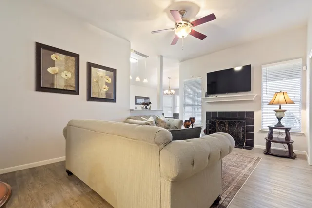 a living room with furniture a fireplace and a flat screen tv