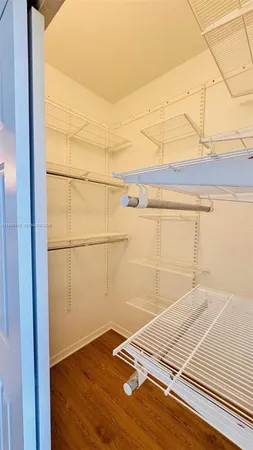 a view of a room with wooden floor