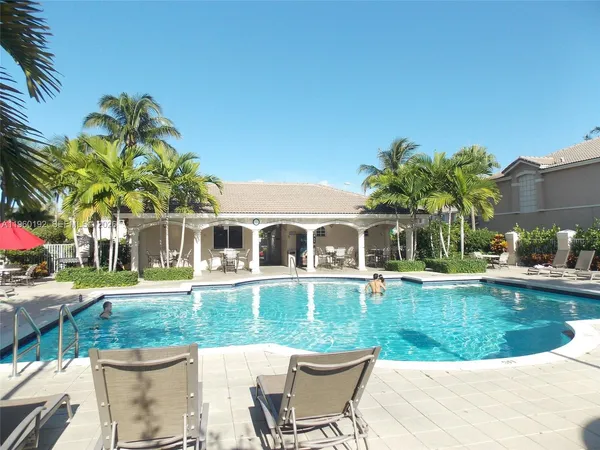 a view of a playground ground and palm trees