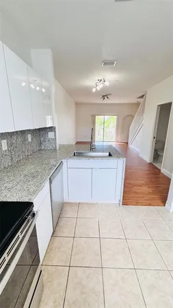 a large kitchen with a stove a sink dishwasher and a microwave