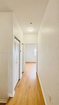a view of a room with wooden floor