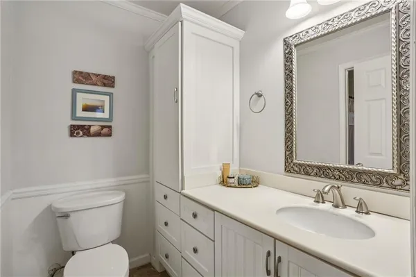 a bathroom with a toilet a sink and mirror