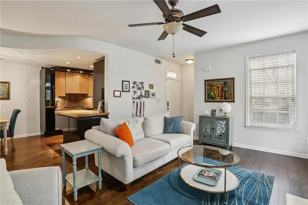 a living room with furniture and a wooden floor