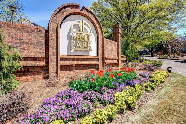 a view of sign board with flower pots