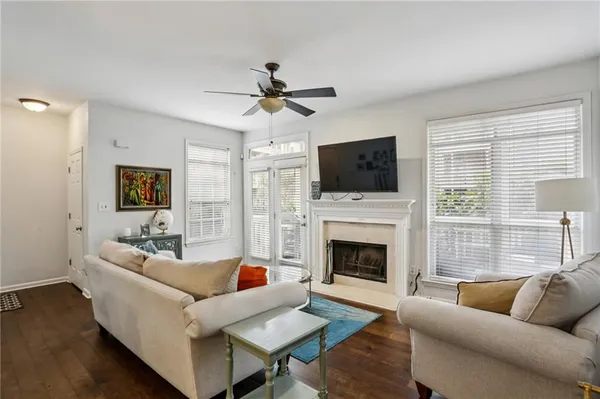 a living room with furniture a fireplace and a flat screen tv