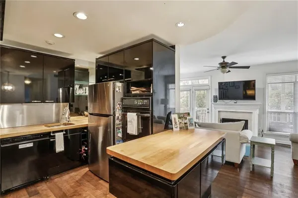 a kitchen with stainless steel appliances granite countertop a stove refrigerator and a microwave