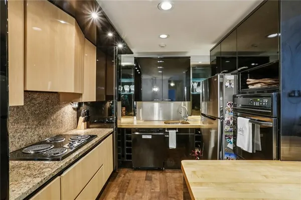 a kitchen with stainless steel appliances granite countertop a stove and a refrigerator