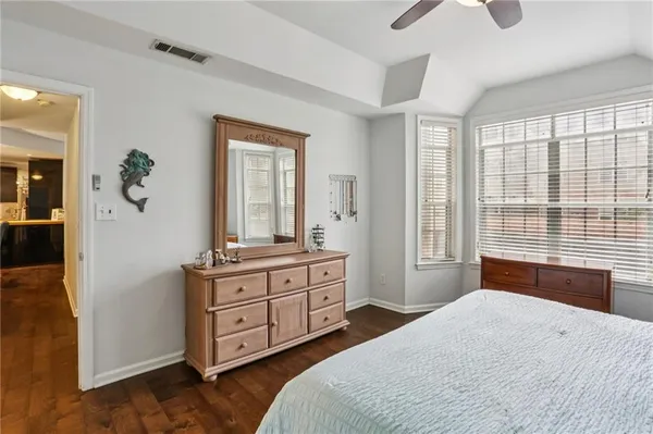a spacious bedroom with a large bed and a dresser