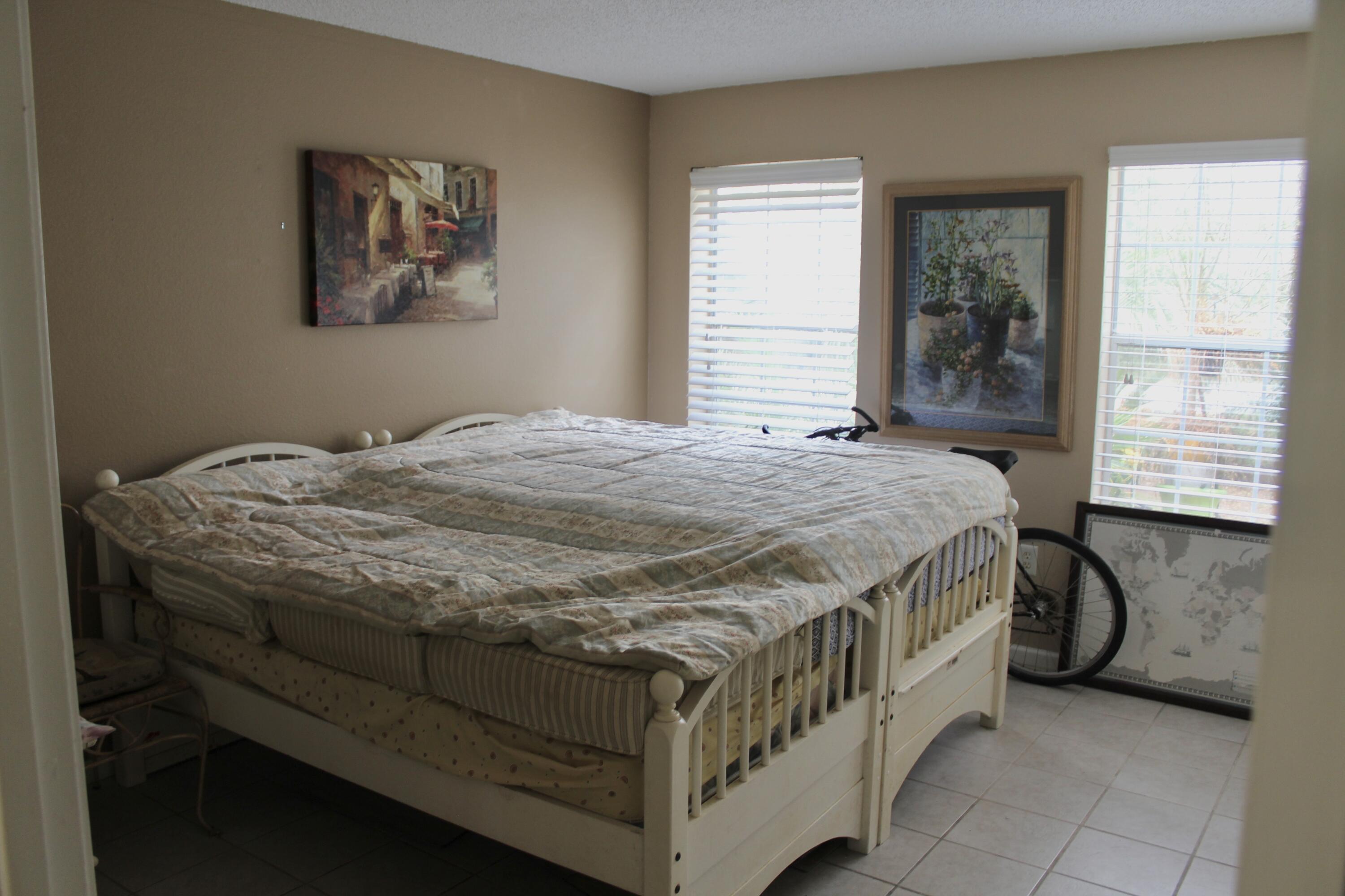 4080 Dancing Cloud Court, Unit 218 Destin, FL 32541 - Photo 14 of 28 a bed sitting in a bedroom next to a window