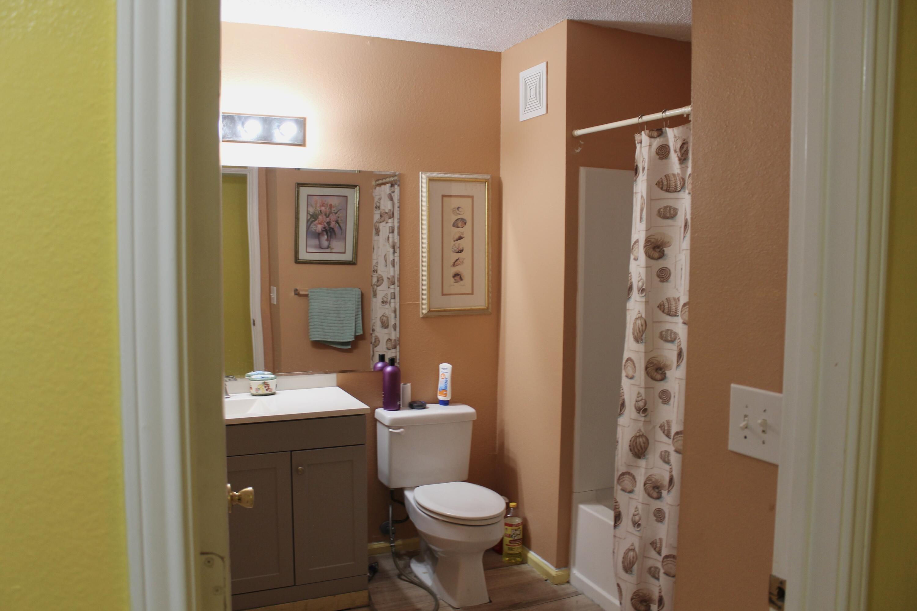 4080 Dancing Cloud Court, Unit 218 Destin, FL 32541 - Photo 16 of 28 a bathroom with a sink toilet and shower