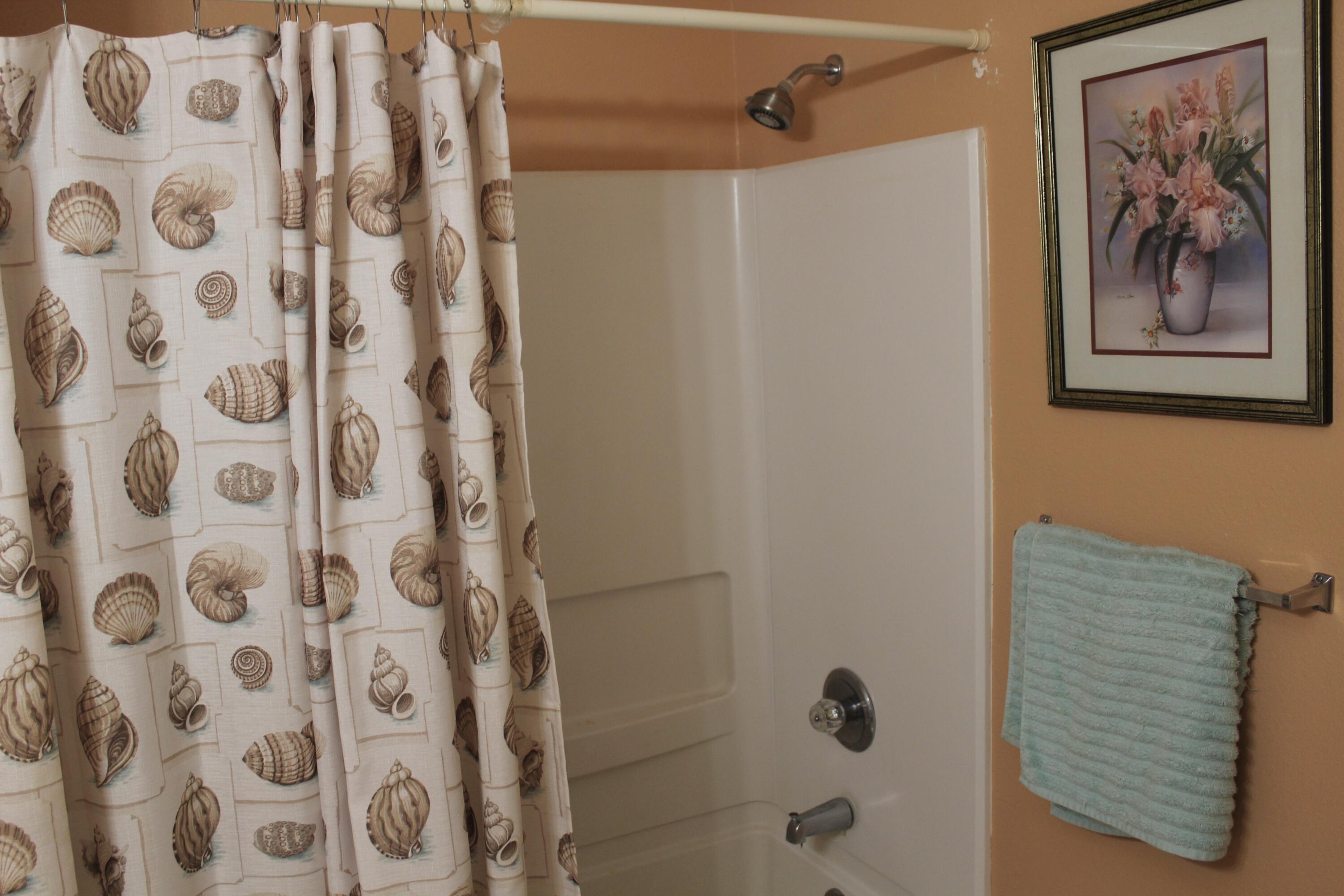 4080 Dancing Cloud Court, Unit 218 Destin, FL 32541 - Photo 17 of 28 a bathroom with a shower curtain