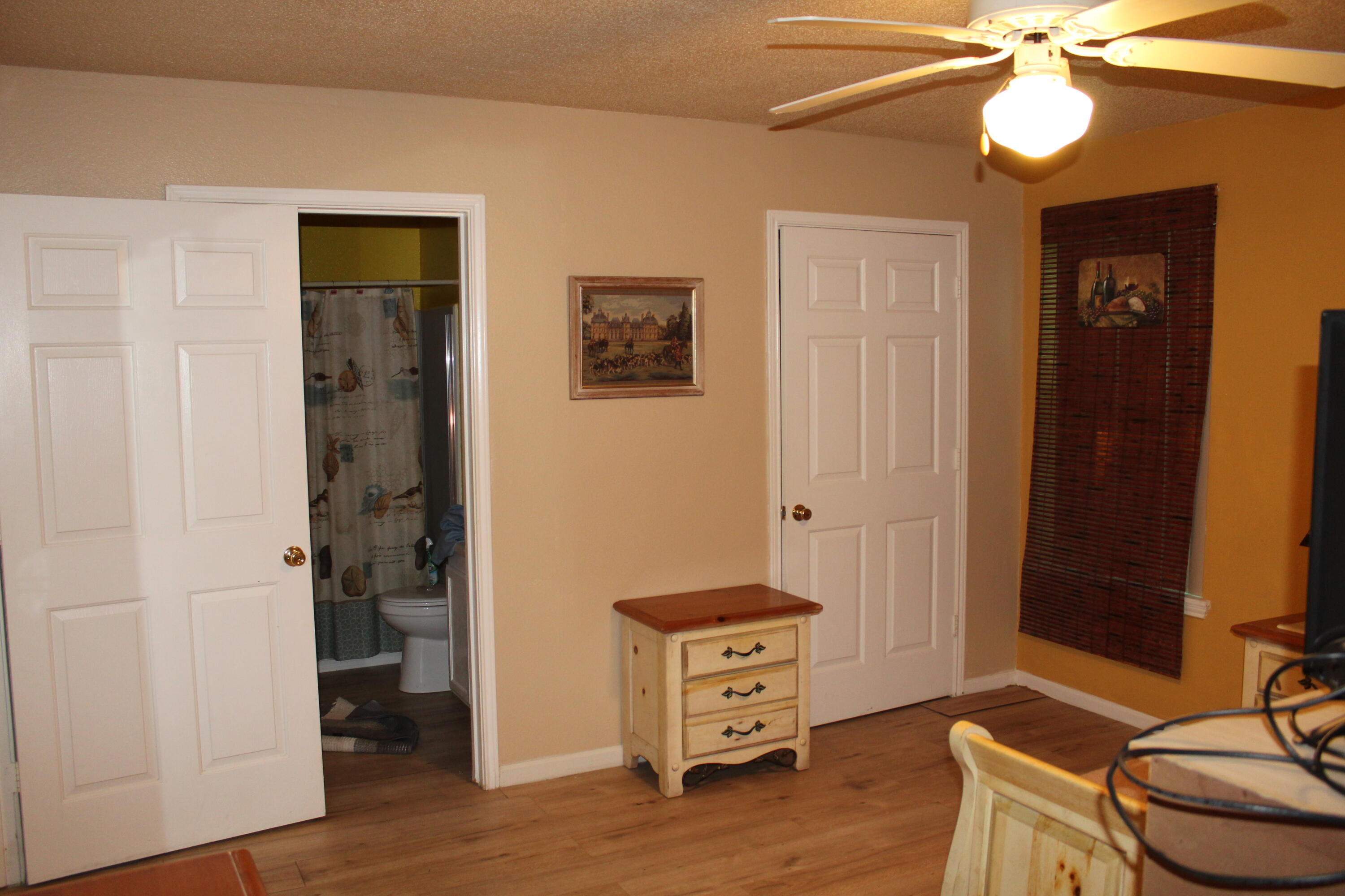 4080 Dancing Cloud Court, Unit 218 Destin, FL 32541 - Photo 22 of 28 a room with furniture and wooden floor