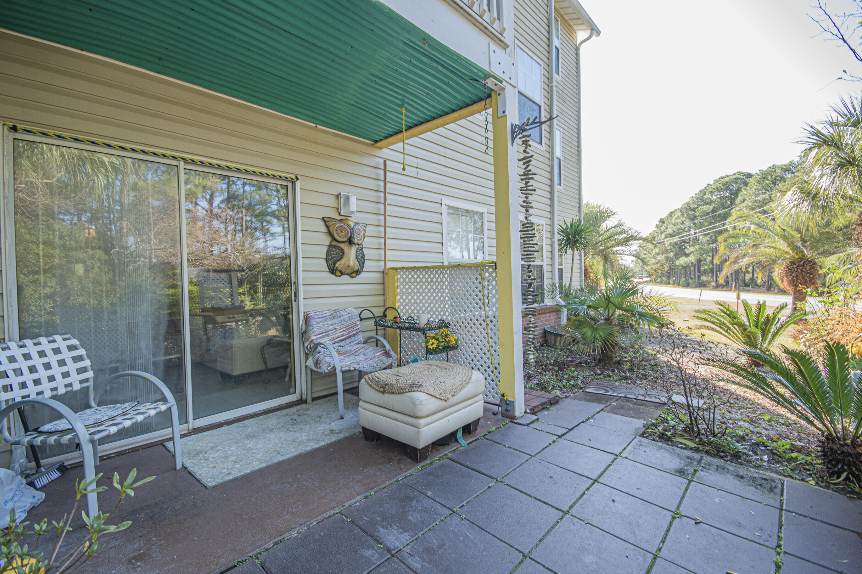 4080 Dancing Cloud Court, Unit 218 Destin, FL 32541 - Photo 23 of 28 a bedroom with a balcony a bed and a chair