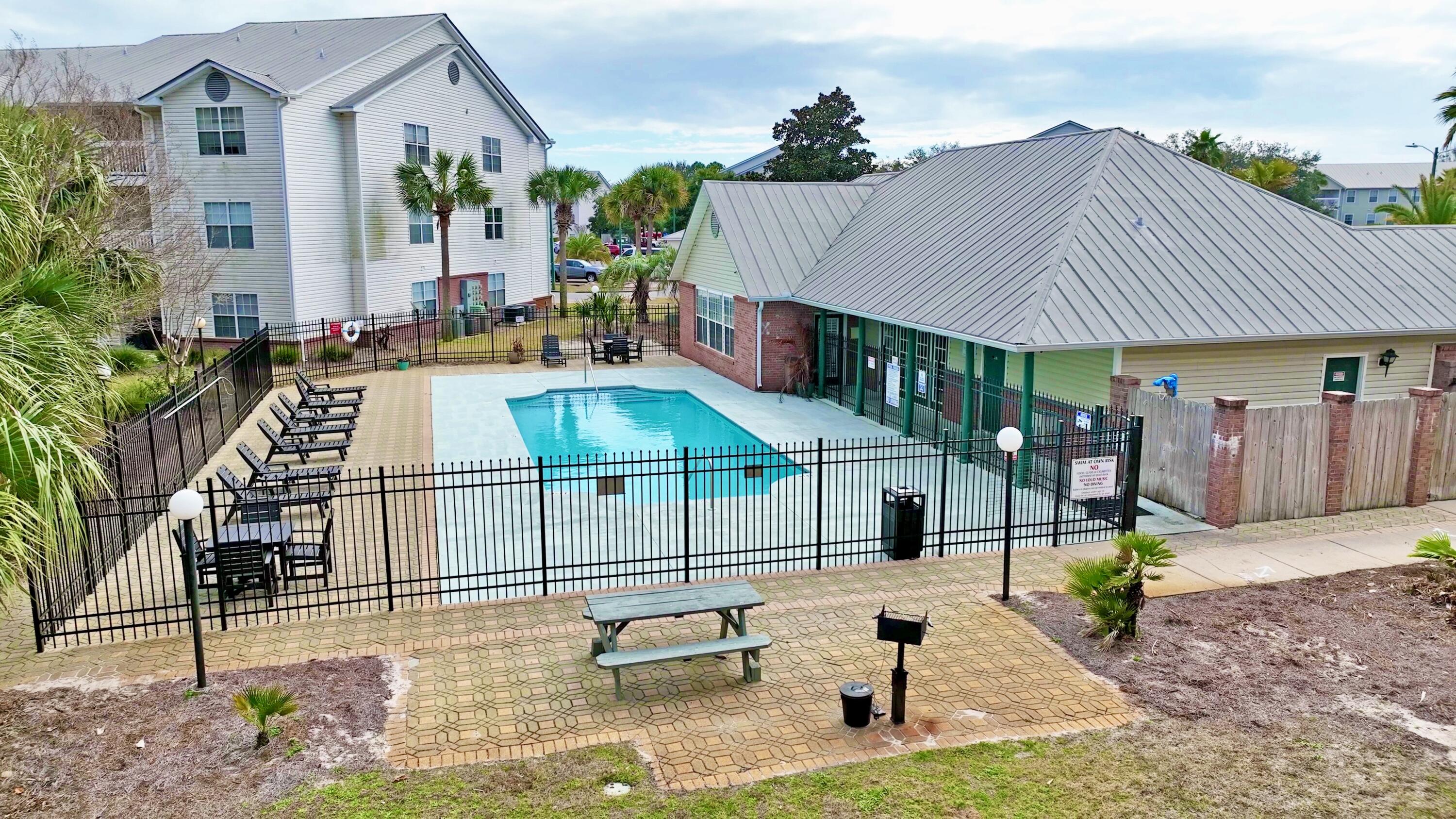 4080 Dancing Cloud Court, Unit 218 Destin, FL 32541 - Photo 28 of 28 a view of a patio with a table and chairs under an umbrella