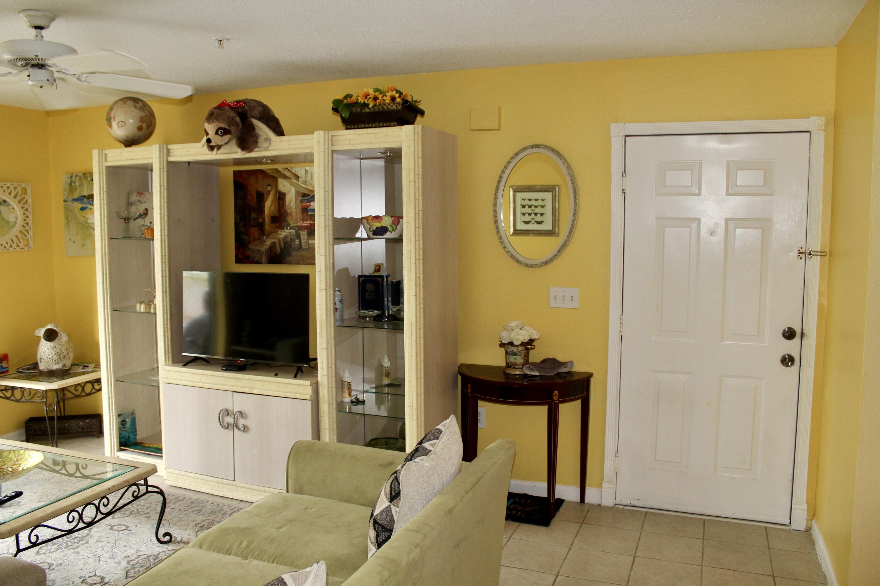 4080 Dancing Cloud Court, Unit 218 Destin, FL 32541 - Photo 7 of 28 a living room with stainless steel appliances furniture and a flat screen tv
