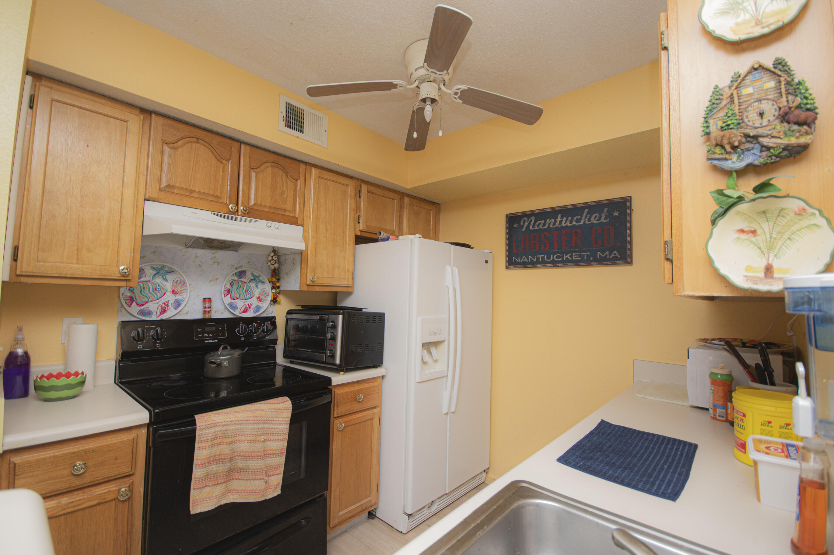 4080 Dancing Cloud Court, Unit 218 Destin, FL 32541 - Photo 10 of 28 a kitchen with stainless steel appliances a stove a refrigerator and cabinets