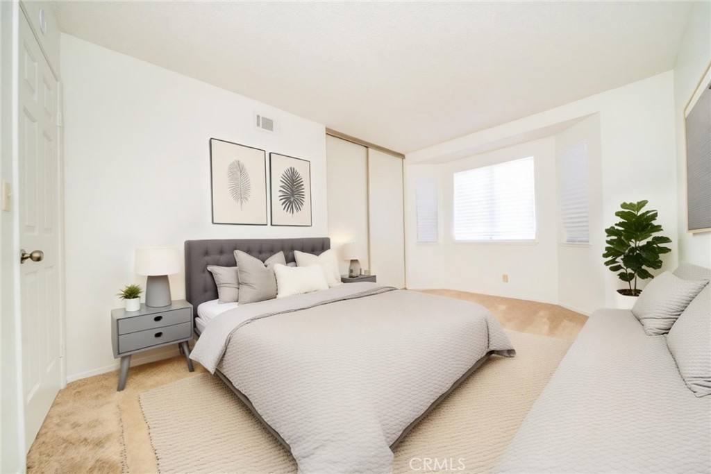 1385 West Wedgewood Street Rialto, CA 92376 - Photo 17 of 27 a bedroom with a bed and a potted plant