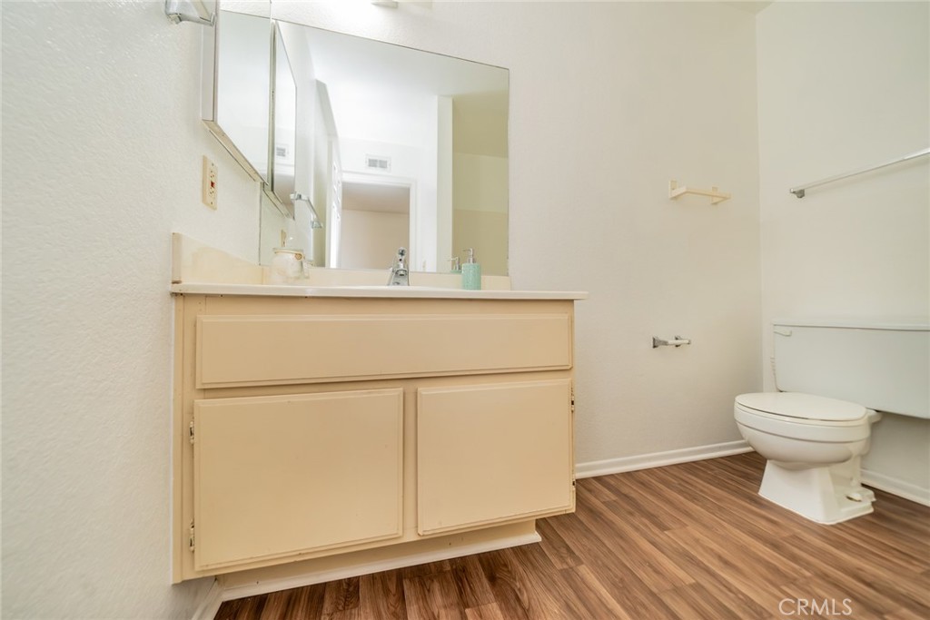 1385 West Wedgewood Street Rialto, CA 92376 - Photo 19 of 27 a bathroom with a toilet a sink and mirror
