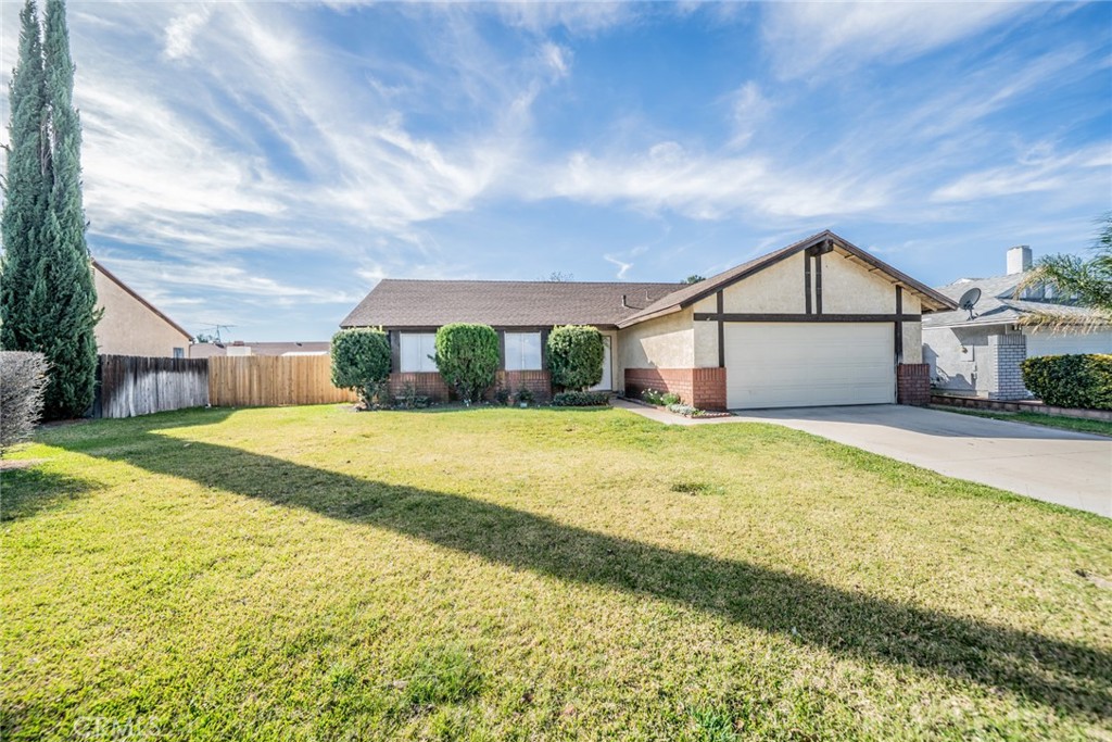 1385 West Wedgewood Street Rialto, CA 92376 - Photo 2 of 27 a front view of a house with a yard