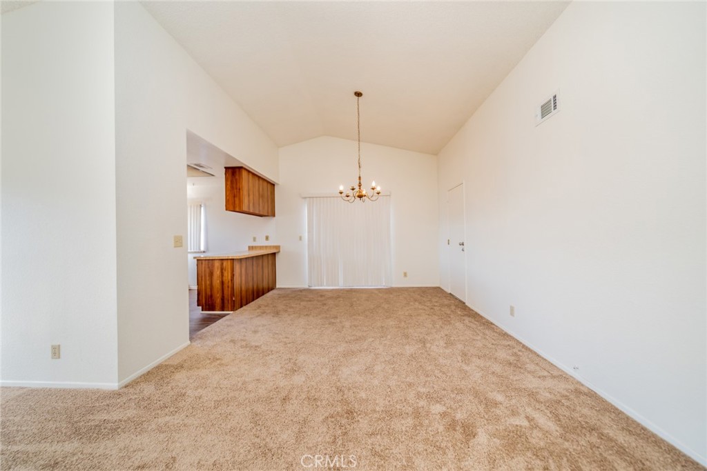1385 West Wedgewood Street Rialto, CA 92376 - Photo 7 of 27 an empty room with a ceiling fan and a window