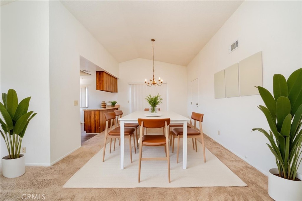 1385 West Wedgewood Street Rialto, CA 92376 - Photo 8 of 27 a dining room with furniture potted plants and wooden floor