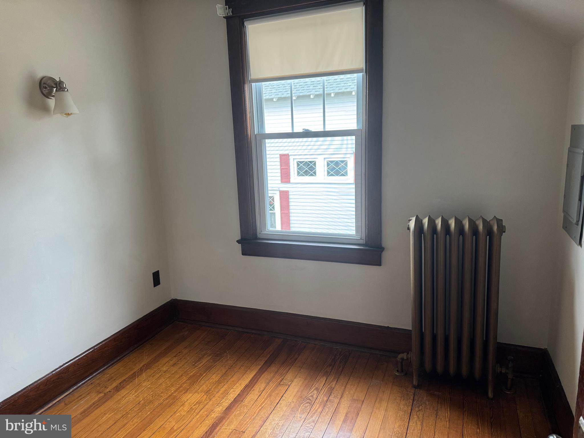307 Edgewood Avenue Delanco, NJ 08075 - Photo 7 of 16 a view of an empty room with wooden floor and a window