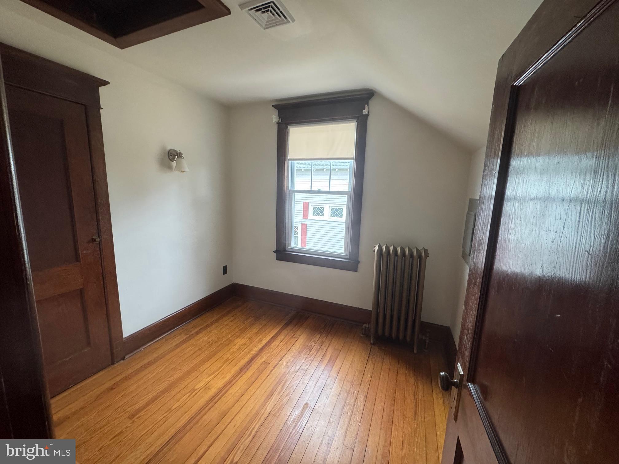 307 Edgewood Avenue Delanco, NJ 08075 - Photo 8 of 16 an empty room with wooden floor and windows