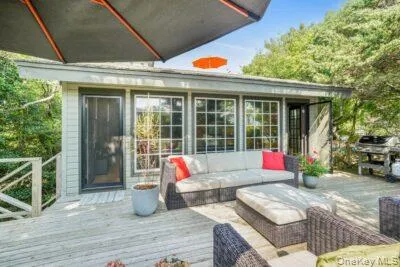 a outdoor space with patio the couches and a dining table and chairs with wooden floor