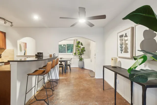 a kitchen with stainless steel appliances granite countertop a refrigerator and a stove top oven