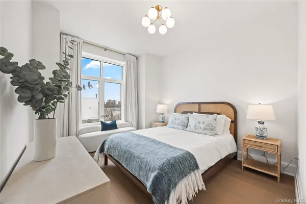 a bedroom with a bed and a potted plant