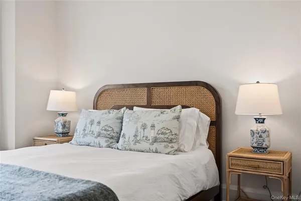 a bedroom with a bed and a lamp on table