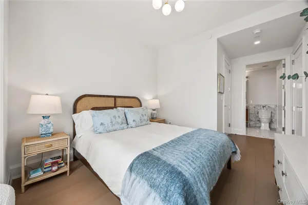 a bedroom with a bed and a lamp