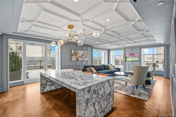 a view of a dining room with furniture wooden floor and chandelier