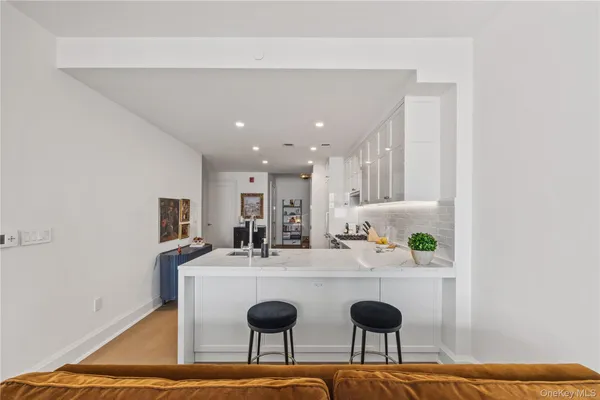 a room with stainless steel appliances kitchen island a table and chairs in it