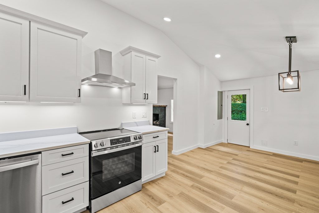 514 Ash Loop Road Blue Ridge, GA 30513 - Photo 11 of 24 a kitchen with granite countertop a stove and a sink