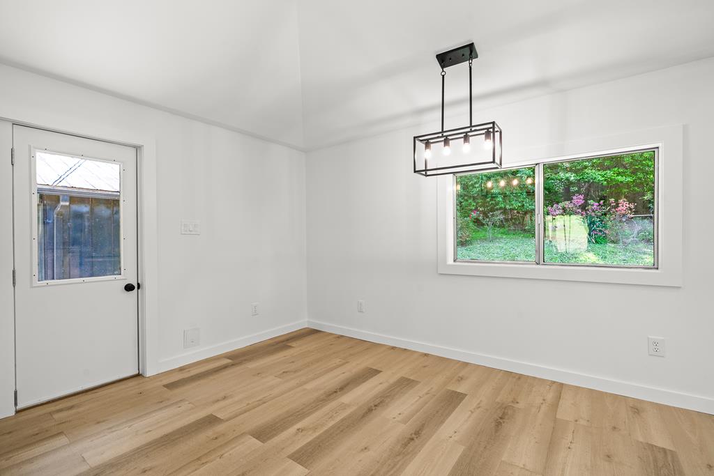 514 Ash Loop Road Blue Ridge, GA 30513 - Photo 13 of 24 an empty room with wooden floor and windows