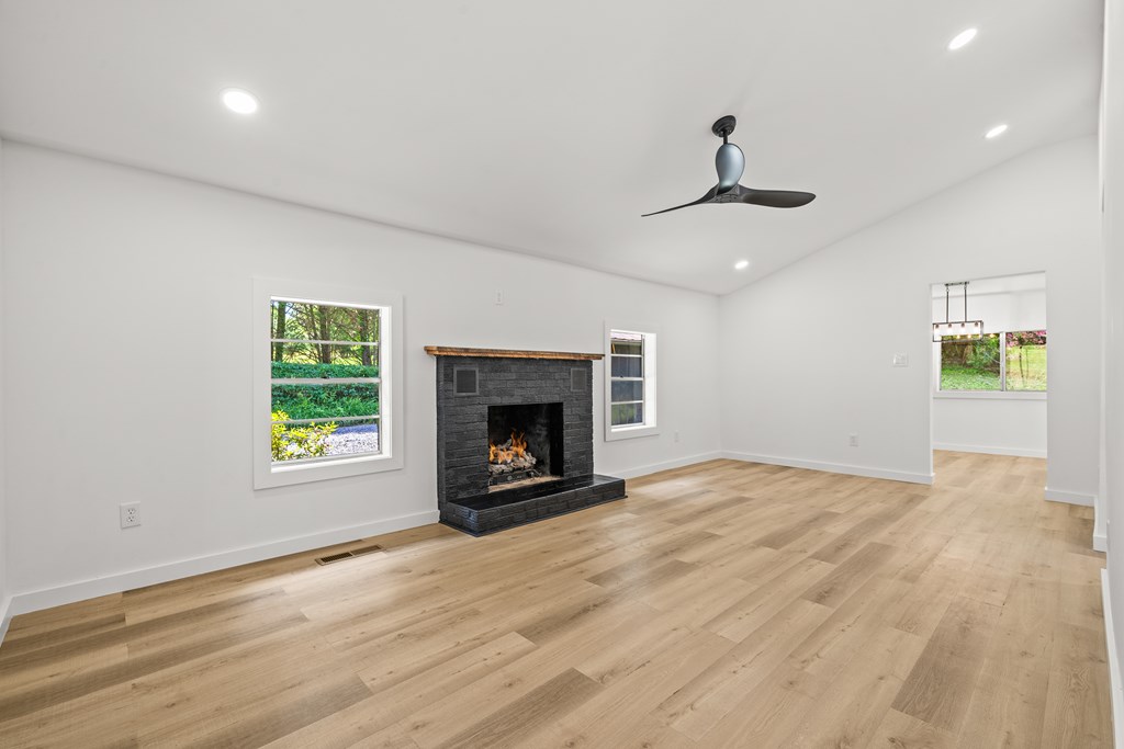 514 Ash Loop Road Blue Ridge, GA 30513 - Photo 7 of 24 a view of an empty room with a window and a fireplace