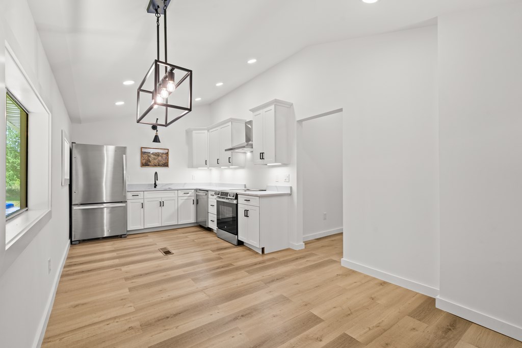 514 Ash Loop Road Blue Ridge, GA 30513 - Photo 9 of 24 a kitchen with stainless steel appliances a refrigerator a sink dishwasher a stove and white cabinets