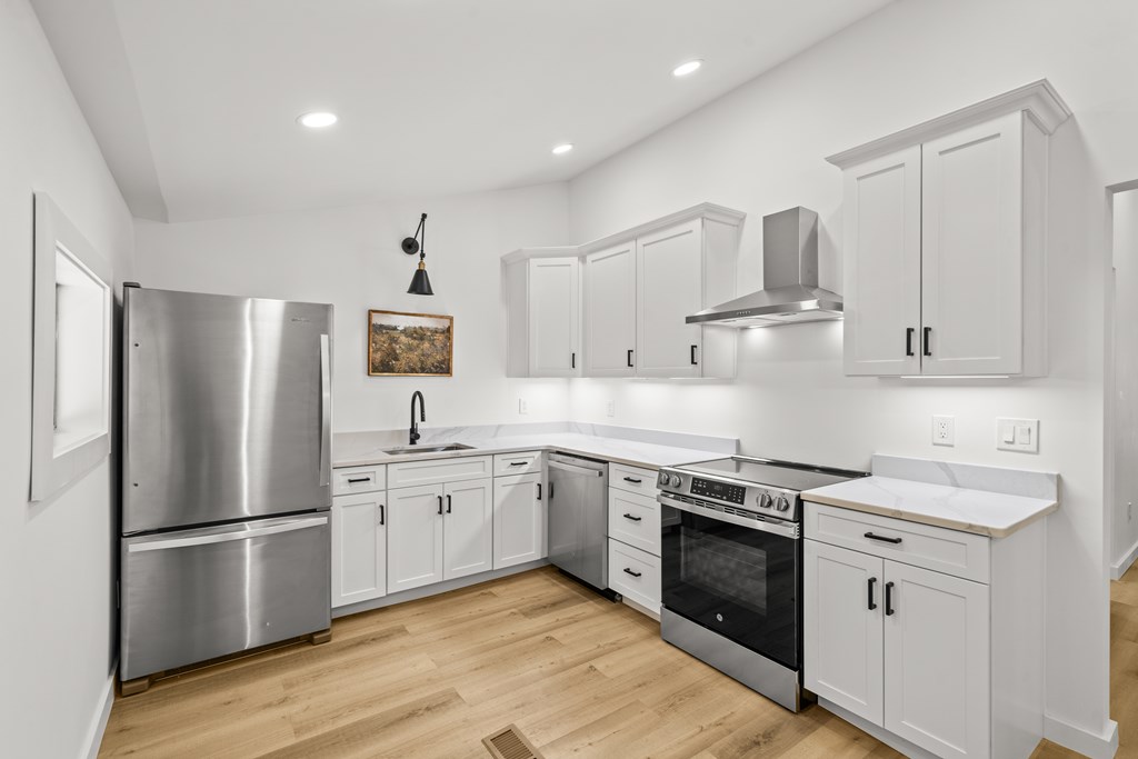 514 Ash Loop Road Blue Ridge, GA 30513 - Photo 10 of 24 a kitchen with stainless steel appliances a stove a sink and a refrigerator