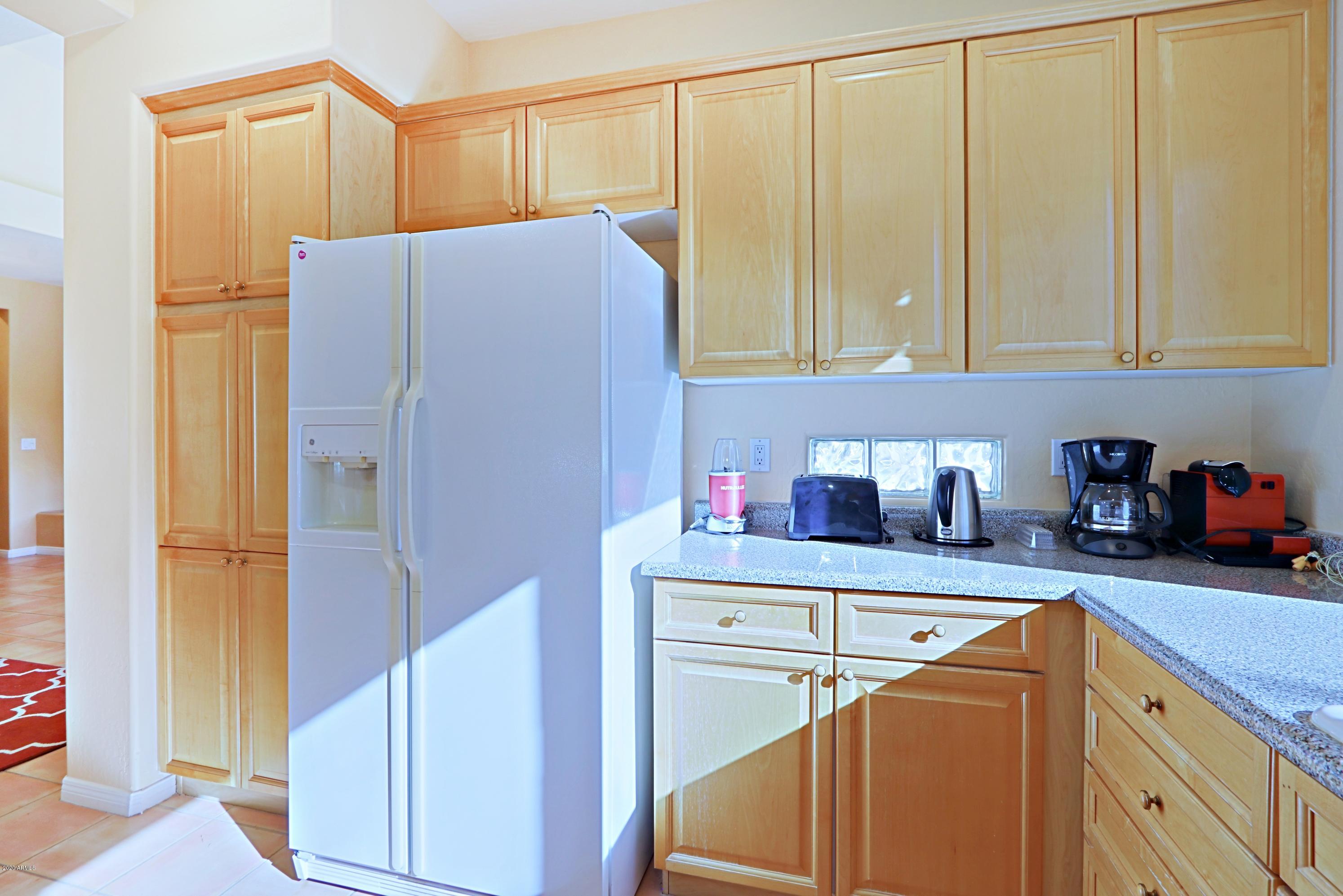 6803 East Eagle Feather Road Scottsdale, AZ 85266 - Photo 11 of 67 a kitchen with stainless steel appliances granite countertop a refrigerator and a sink