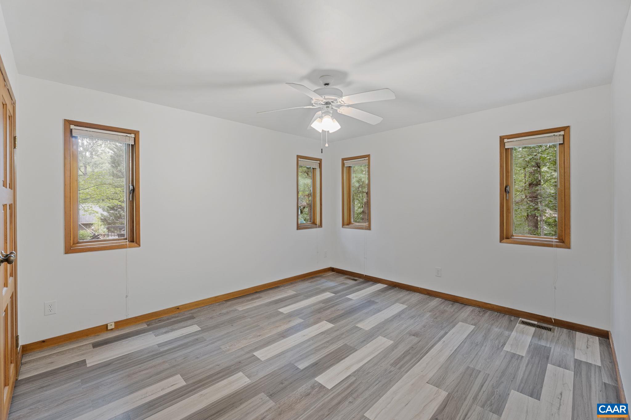 13 Axle Tree Road Palmyra, VA 22963 - Photo 47 of 71 a view of empty room with wooden floor and fan